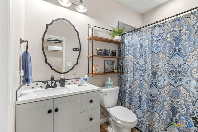 312 Holly Ave, Luling, TX 78648 - full bath featuring vanity, a wall mounted air conditioner, a shower with shower curtain, and a textured wall