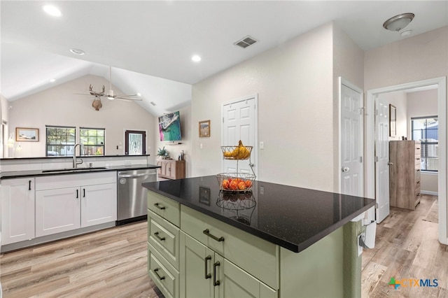 312 Holly Ave, Luling, TX 78648 - kitchen with dishwasher, light wood-type flooring, green cabinets, recessed lighting, and vaulted ceiling