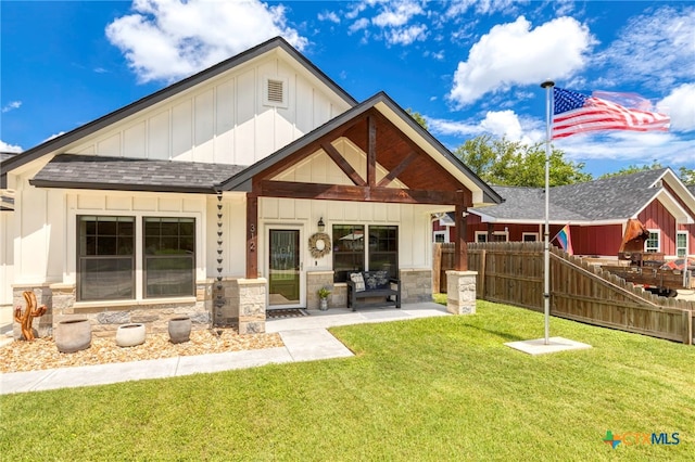 312 Holly Ave, Luling, TX 78648 - rear view of property with board and batten siding, a shingled roof, and stone siding