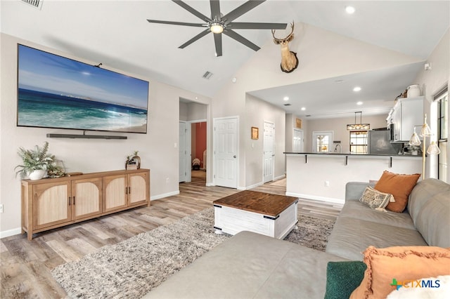 312 Holly Ave, Luling, TX 78648 - living room featuring light wood-style flooring, ceiling fan, high vaulted ceiling, and recessed lighting