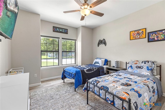 312 Holly Ave, Luling, TX 78648 - bedroom featuring wood finished floors and a ceiling fan
