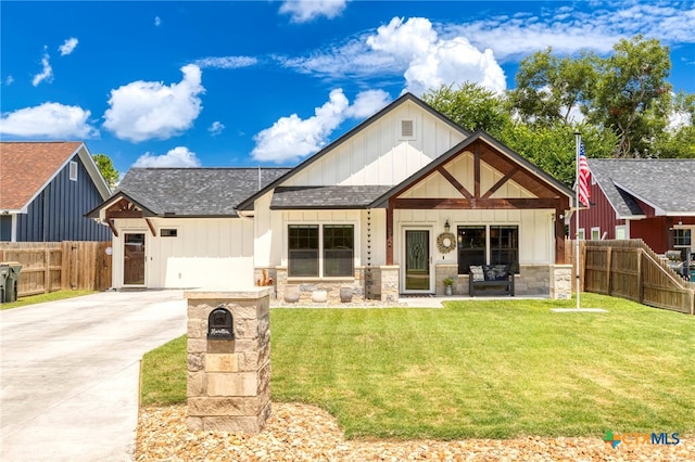 312 Holly Ave, Luling, TX 78648 - view of front of property featuring board and batten siding, a shingled roof, driveway, and stone siding
