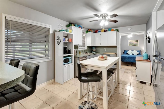 2812 Curlew St, Victoria, TX 77901 - kitchen featuring ceiling fan, light tile patterned floors, white cabinets, and open shelves