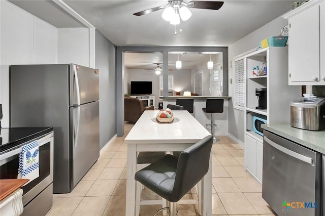2812 Curlew St, Victoria, TX 77901 - kitchen featuring a ceiling fan, appliances with stainless steel finishes, white cabinetry, and light countertops