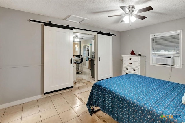 2812 Curlew St, Victoria, TX 77901 - bedroom featuring a barn door, light tile patterned floors, a textured ceiling, cooling unit, and ceiling fan