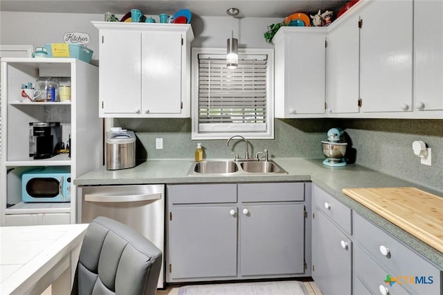 2812 Curlew St, Victoria, TX 77901 - kitchen featuring dishwasher, light countertops, white cabinetry, and white microwave