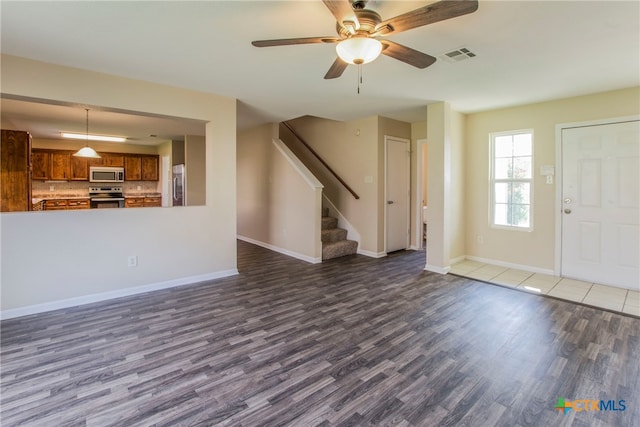 unfurnished living room with ceiling fan and hardwood / wood-style flooring