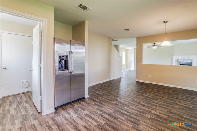 kitchen with a fireplace, stainless steel fridge with ice dispenser, dark hardwood / wood-style floors, and ceiling fan