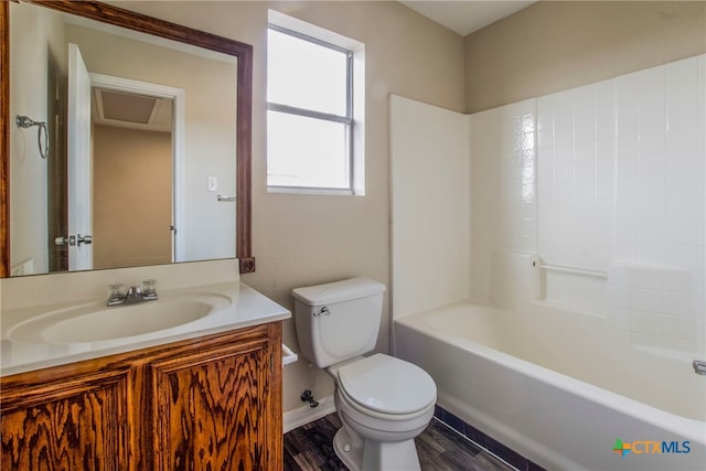 full bathroom with hardwood / wood-style floors, vanity, toilet, and shower / washtub combination