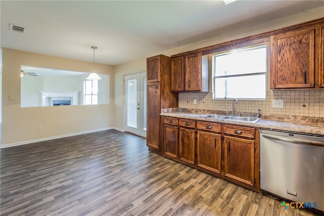 kitchen with a healthy amount of sunlight, dishwasher, dark wood-type flooring, and sink