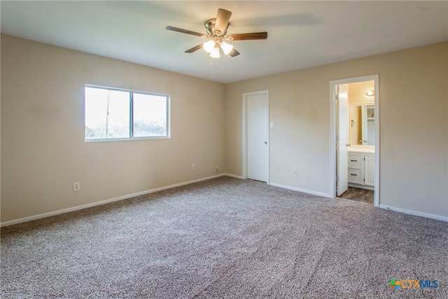 unfurnished bedroom featuring carpet, ensuite bathroom, and ceiling fan