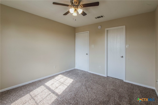 unfurnished bedroom with ceiling fan and carpet