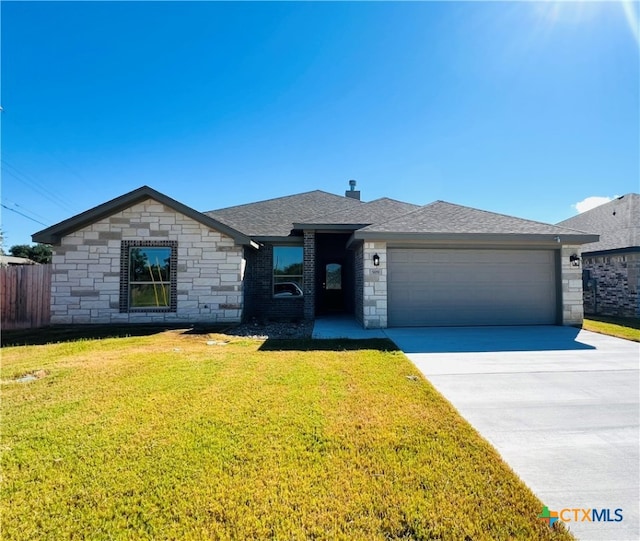 ranch-style home with a garage and a front lawn