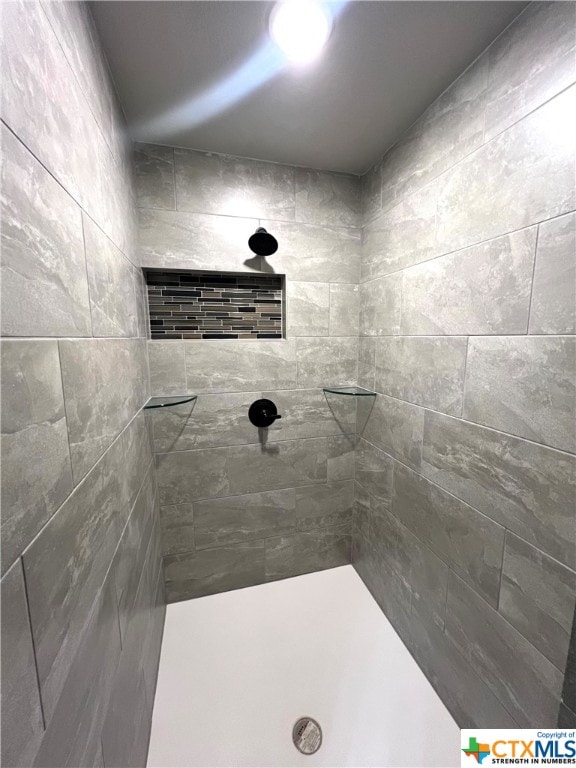 bathroom with tiled shower