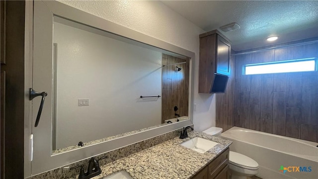 2408 Duntov Dr, Temple, TX 76504 - bathroom featuring vanity, toilet, a textured ceiling, and shower / washtub combination
