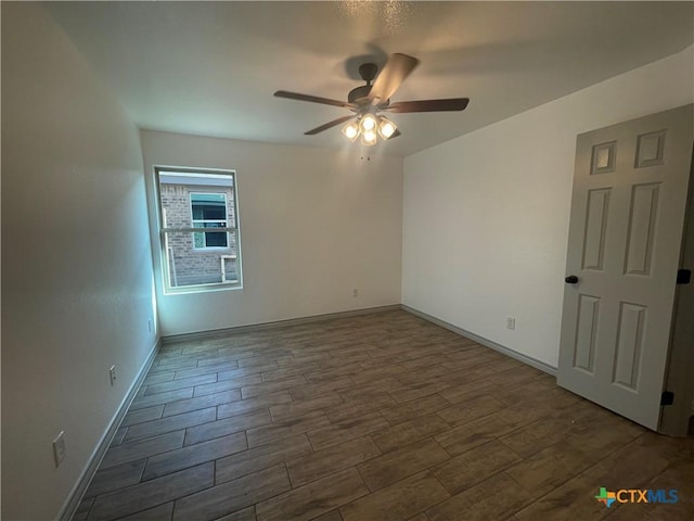 2408 Duntov Dr, Temple, TX 76504 - empty room with a ceiling fan, dark wood finished floors, and baseboards