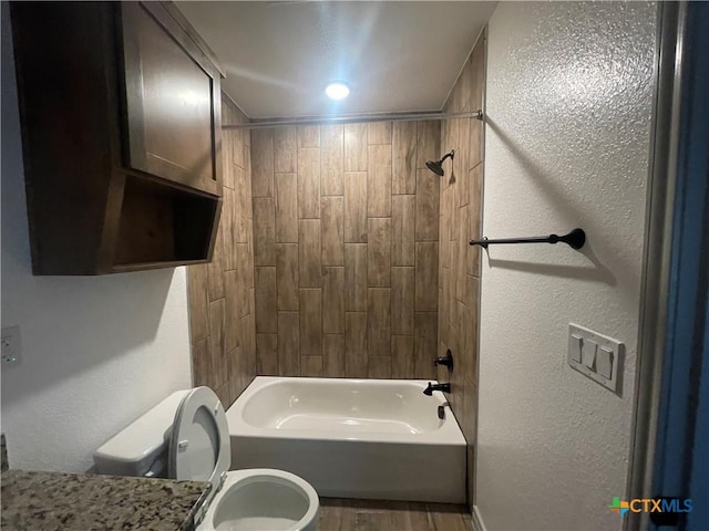 2408 Duntov Dr, Temple, TX 76504 - full bath featuring toilet, wood finished floors, shower / washtub combination, and a textured wall