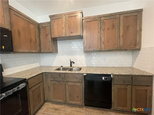 2408 Duntov Dr, Temple, TX 76504 - kitchen with black appliances, a sink, decorative backsplash, and light stone counters