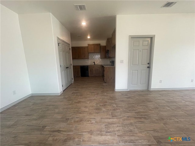 2408 Duntov Dr, Temple, TX 76504 - unfurnished living room with baseboards, wood finished floors, recessed lighting, and a sink
