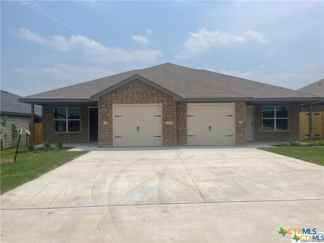 2408 Duntov Dr, Temple, TX 76504 - single story home featuring an attached garage, brick siding, and concrete driveway