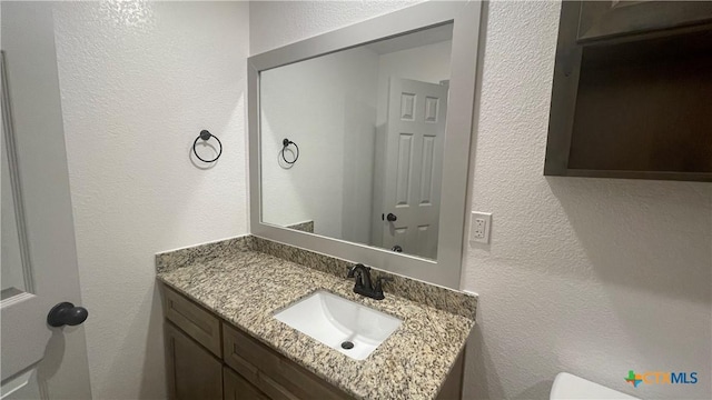 2408 Duntov Dr, Temple, TX 76504 - bathroom featuring vanity, toilet, and a textured wall