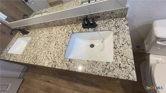 2408 Duntov Dr, Temple, TX 76504 - bathroom featuring toilet, wood finished floors, and vanity