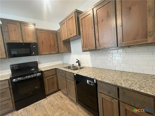 2408 Duntov Dr, Temple, TX 76504 - kitchen featuring black appliances, a sink, decorative backsplash, and light stone counters