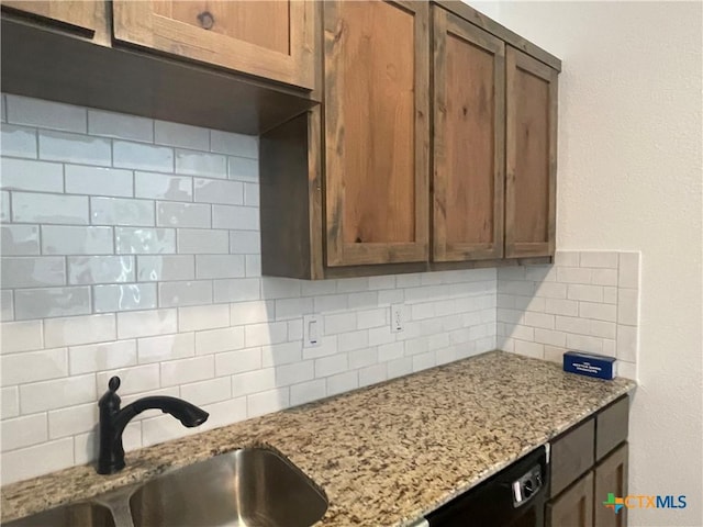 2408 Duntov Dr, Temple, TX 76504 - kitchen featuring a sink, backsplash, dishwasher, light stone counters, and brown cabinets
