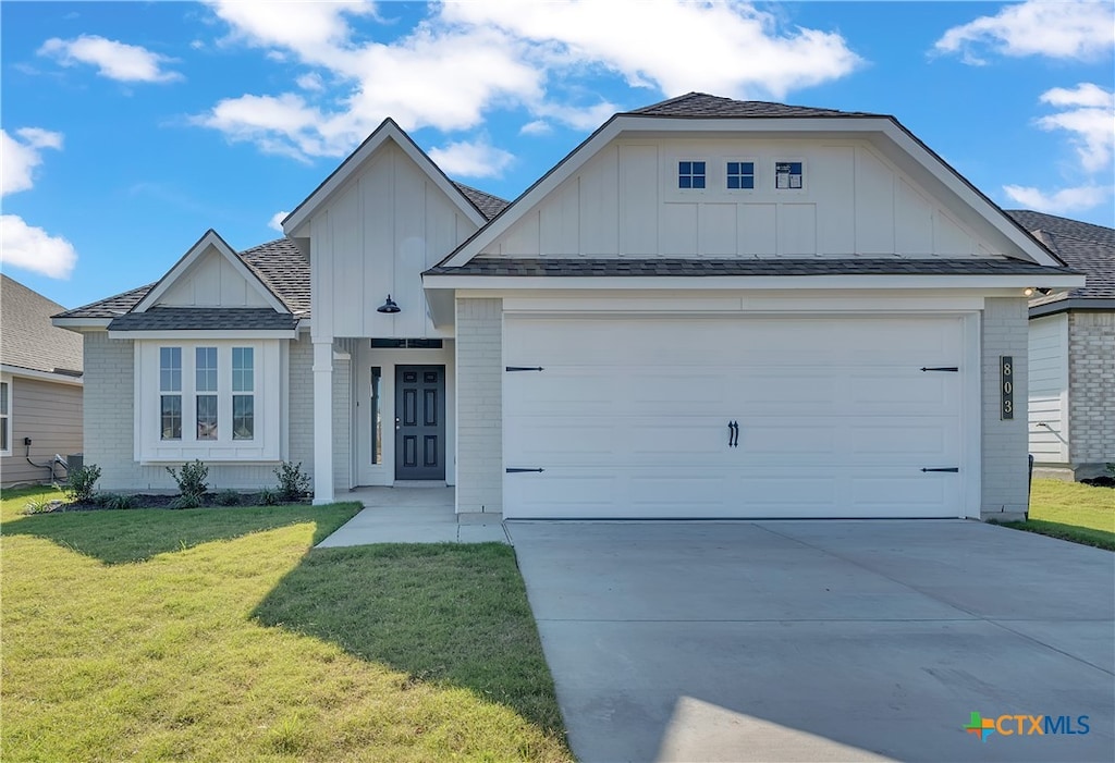 view of front facade with a garage and a front lawn