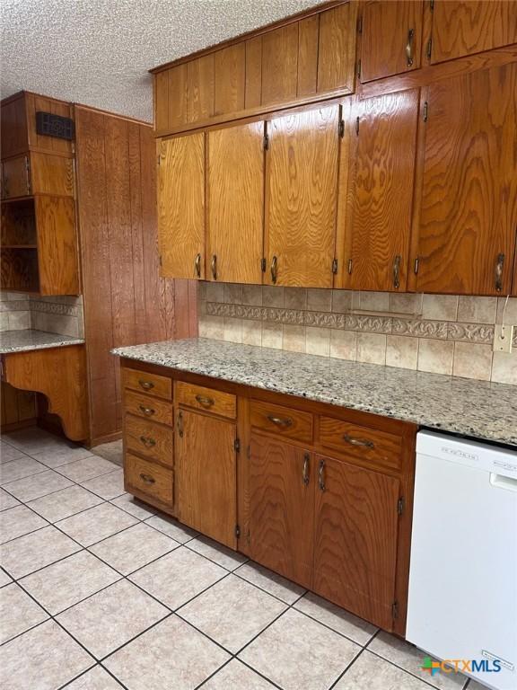 kitchen featuring light tile patterned flooring, decorative backsplash, dishwasher, and open shelves