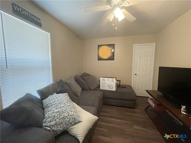 living room with dark wood-style floors and a ceiling fan