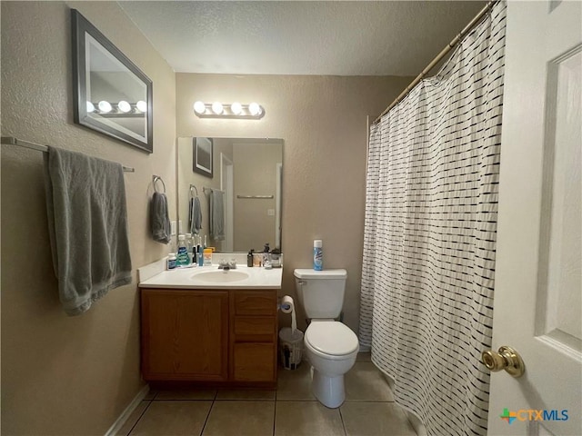 full bath with tile patterned floors, toilet, a textured ceiling, baseboards, and vanity