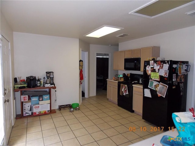 kitchen featuring light tile patterned floors, visible vents, light brown cabinetry, black appliances, and light countertops