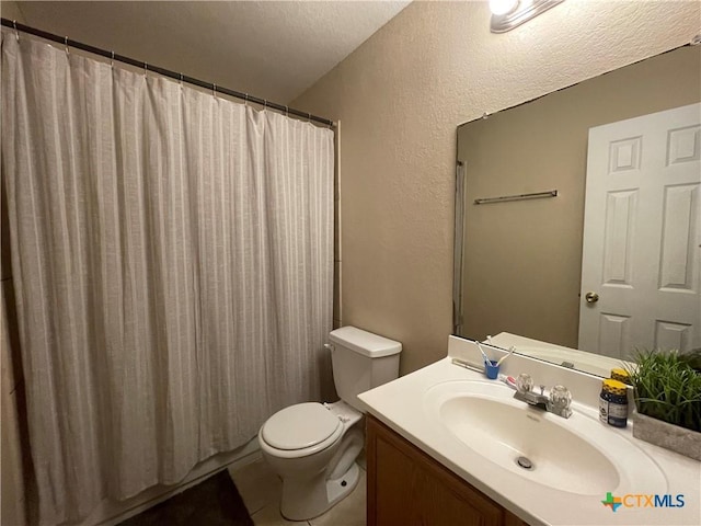 bathroom featuring a shower with shower curtain, toilet, vanity, and a textured wall