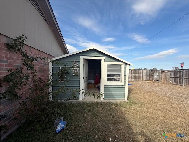 view of outbuilding with a yard