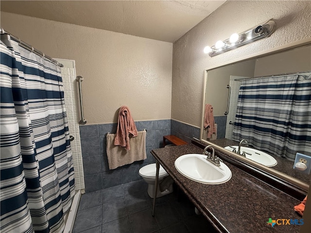 bathroom featuring tile patterned flooring, toilet, tile walls, and a shower with shower curtain