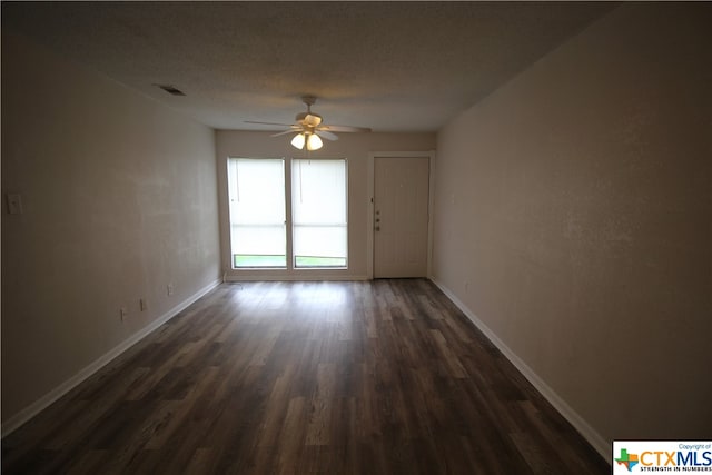 unfurnished room featuring ceiling fan and dark hardwood / wood-style flooring