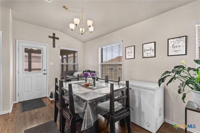 853 Hobby Rd, Copperas Cove, TX 76522 - dining space with a chandelier, vaulted ceiling, dark wood-style floors, and baseboards