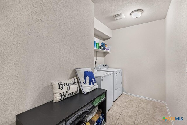 853 Hobby Rd, Copperas Cove, TX 76522 - laundry area featuring separate washer and dryer, baseboards, a textured wall, a textured ceiling, and light tile patterned floors