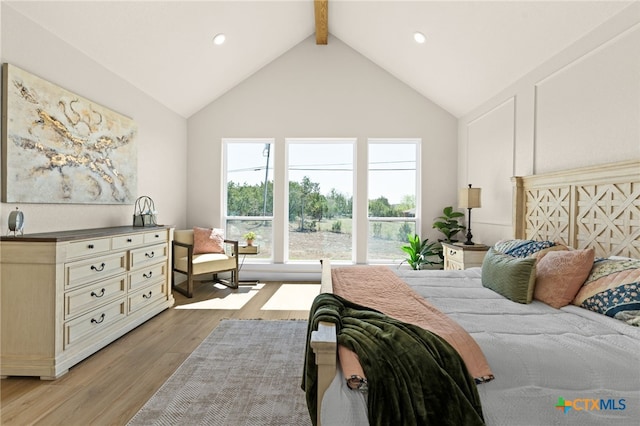 bedroom with beamed ceiling, recessed lighting, high vaulted ceiling, and light wood-style floors