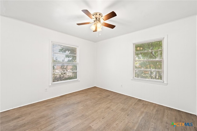 spare room with ceiling fan and wood-type flooring