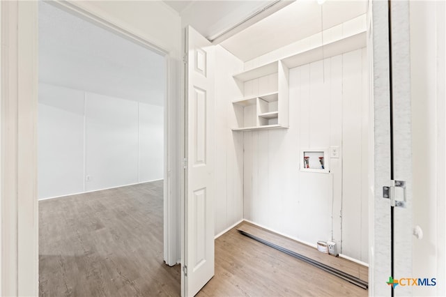 clothes washing area featuring hookup for a washing machine and light hardwood / wood-style floors