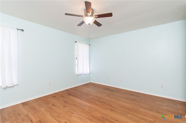 unfurnished room featuring hardwood / wood-style floors and ceiling fan