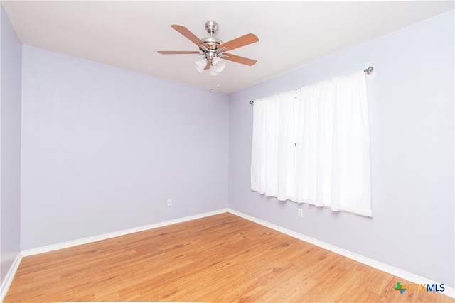 unfurnished room featuring hardwood / wood-style floors and ceiling fan