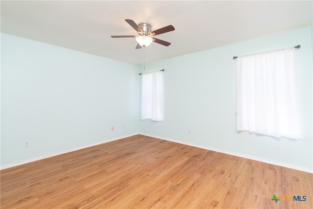 unfurnished room featuring light hardwood / wood-style floors and ceiling fan