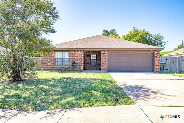 single story home with a garage and a front lawn