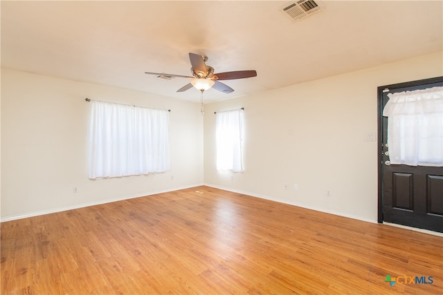 unfurnished room with light hardwood / wood-style flooring and ceiling fan