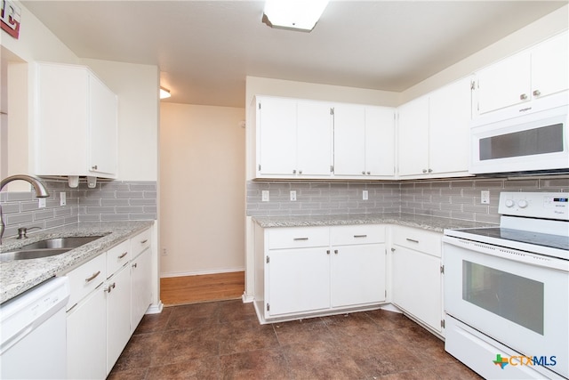 kitchen featuring white appliances, white cabinetry, sink, and decorative backsplash