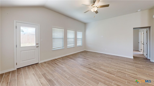 unfurnished living room with light wood finished floors, lofted ceiling, a ceiling fan, and baseboards
