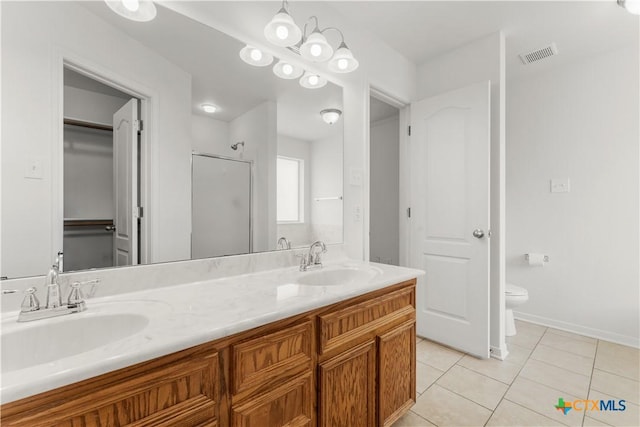 3511 Llano Estacado Ct, Killeen, TX 76549 - bathroom featuring a stall shower, tile patterned floors, double vanity, toilet, and baseboards